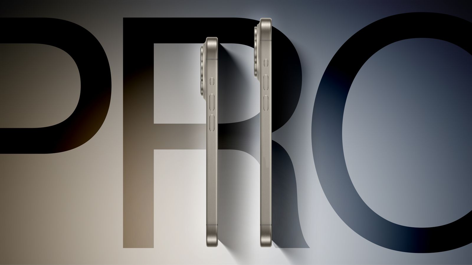 Um protótipo do iPhone 16 Pro (à esquerda) e outro do iPhone 16 Pro Max (à direita), ambos na vertical, mas de perfil, com o ecrã virado para a direita, mostrando os botões de volume e o botão de ação. Atrás, a palavra "PRO".