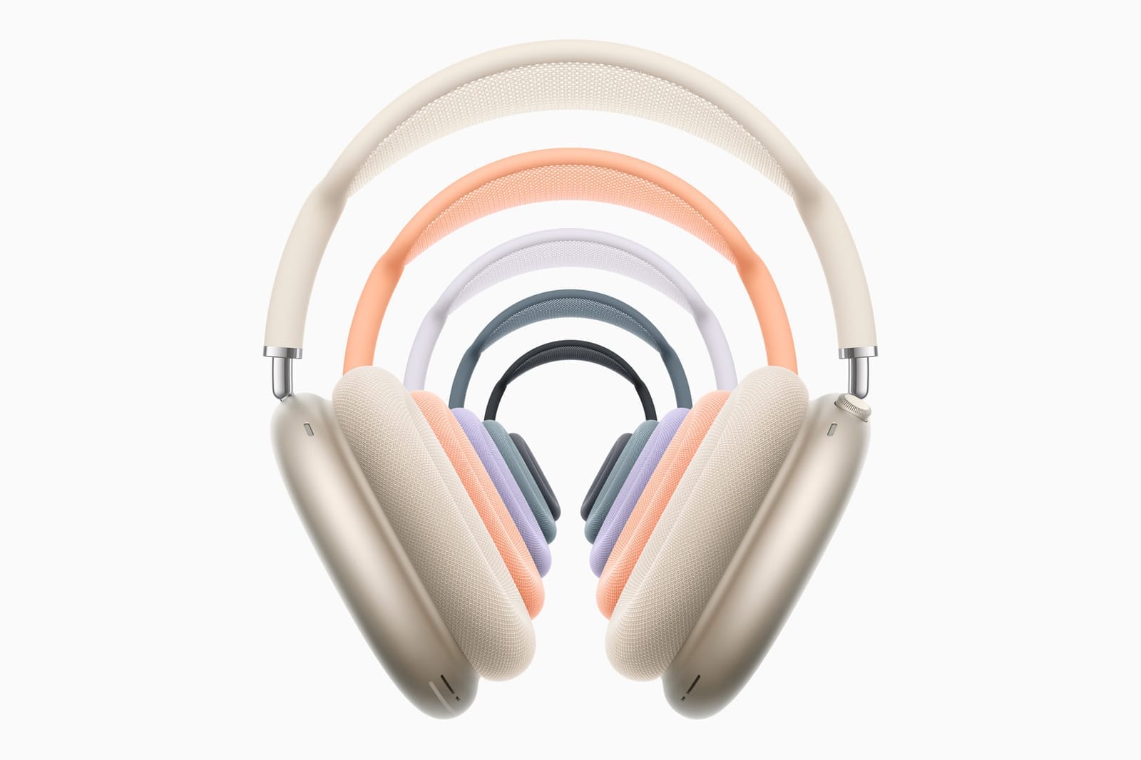 Silver Apple AirPods Max on a wooden table with pot plant in the sun light.